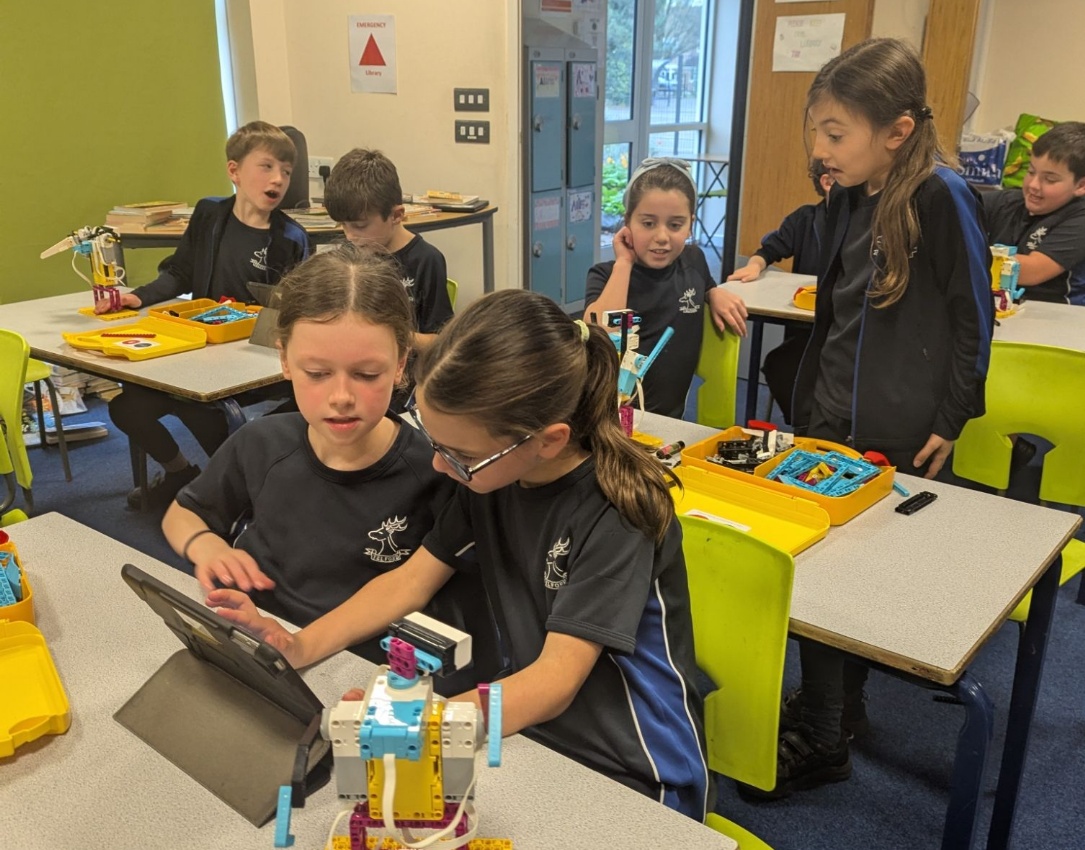 Picture showing pupils working with the robotics kits.